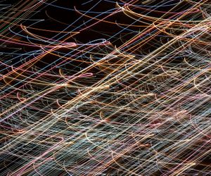 Abstract flowing lines of light on a dark background.