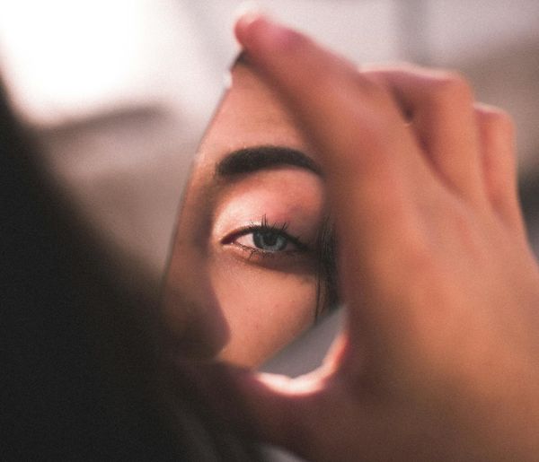 Close-up of a person's eye with abstract light reflections.