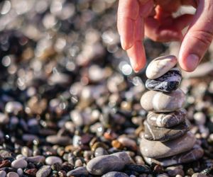 Smooth stones stacked in a zen garden.